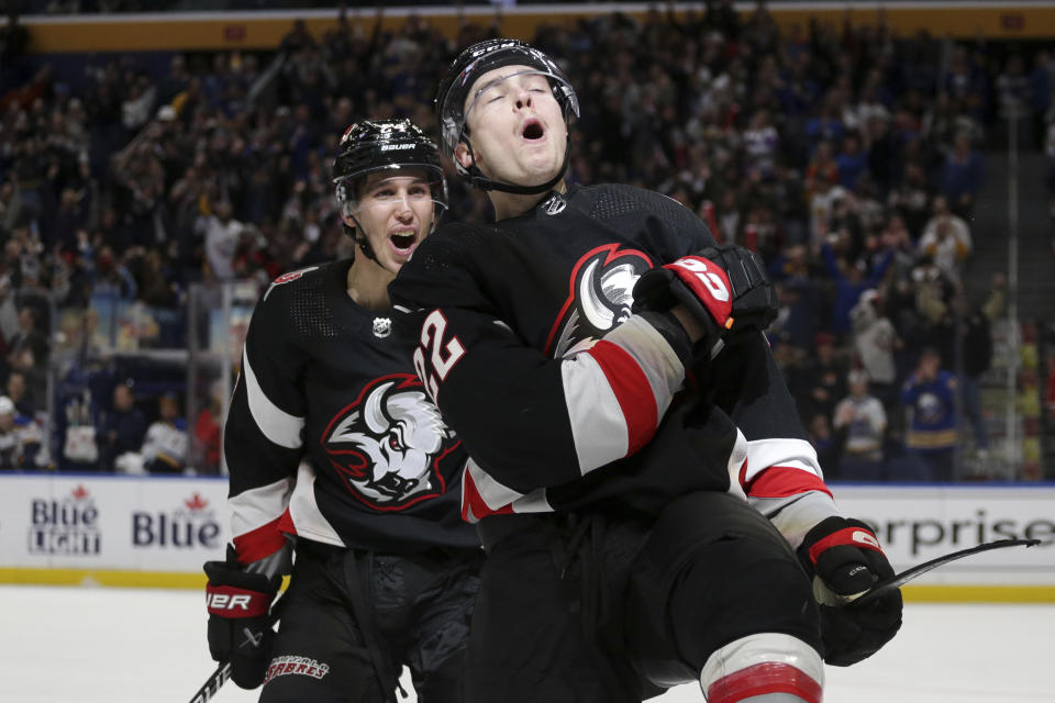 Buffalo Sabres right wing Jack Quinn (22) and center Dylan Cozens, left, celebrate after a goal by Quinn during the third period of an NHL hockey game against the St. Louis Blues on Wednesday, Nov. 23, 2022, in Buffalo, N.Y. (AP Photo/Joshua Bessex)