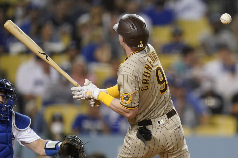 San Diego Padres' Jake Cronenworth (9) reacts after getting hit by a pitch from Los Angeles Dodgers starting pitcher Julio Urias (7) during the third inning of a baseball game Friday, Sept. 10, 2021, in Los Angeles. (AP Photo/Ashley Landis)