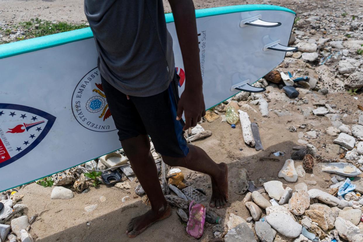 <span>Children on Tierra Bomba can learn water sports such as surfing – if they go to school and help to clean up the beaches and streets. They are also taught about the environment. Leimer Morales, who came through the scheme, now competes for Colombia at paddleboarding. ‘Just as I could get ahead, so can others,’ he says</span><span>Photograph: Charlie Cordero/The Guardian</span>