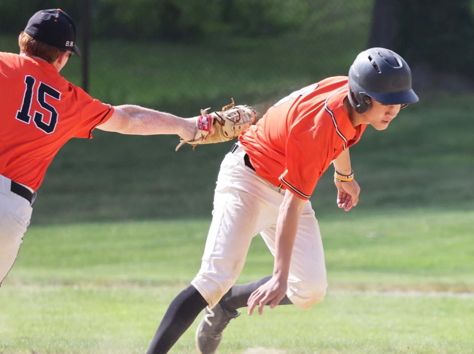 Jake Waxman, of Oliver Ames, tags out Stoughton's Joe McNulty in a rundown during a game on Monday, May 16, 2022.