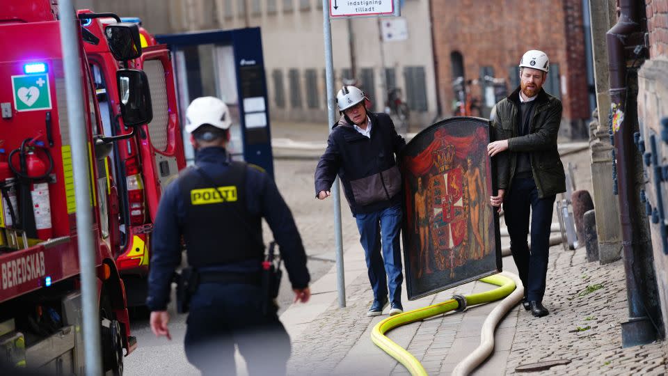 People salvage a painting from the old stock exchange after a violent fire broke out on Tuesday morning. - Ida Marie Odgaard/Ritzau Scanpix/AFP/Getty Images