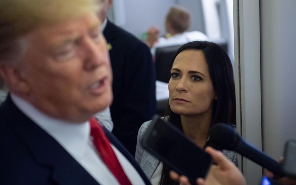 Stephanie Grisham listens in to what President Trump is saying during her time as Press Secretary - Saul Loeb/AFP via Getty