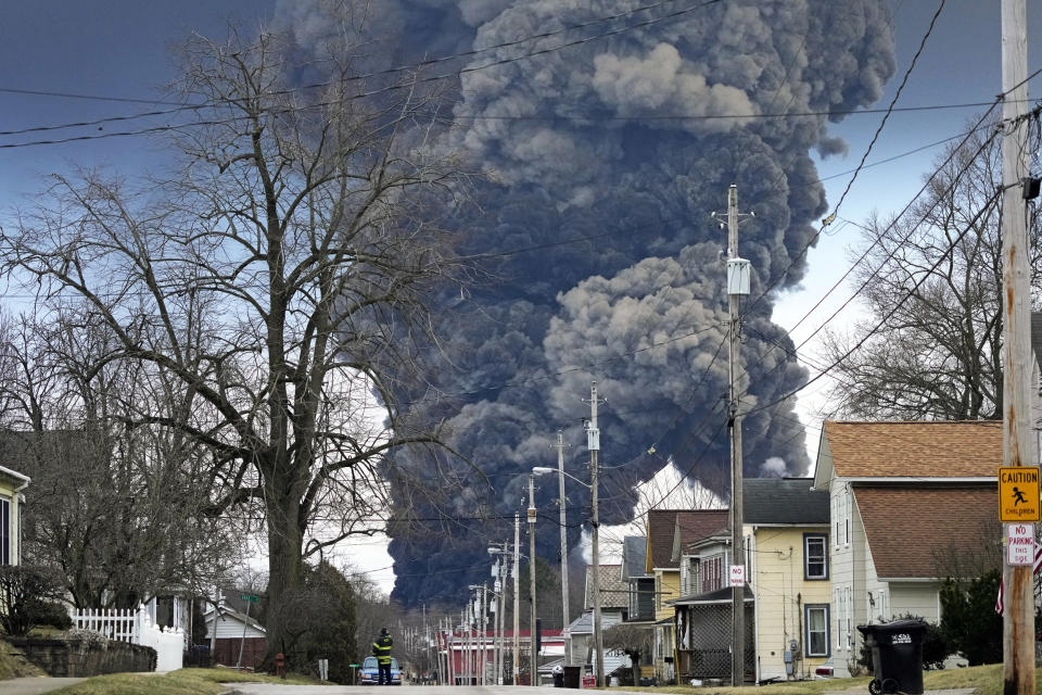 A black plume rises over East Palestine, Ohio, following the controlled detonation of a portion of the derailed Norfolk Southern trains (Gene J. Puskar / AP file)