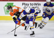 Philadelphia Flyers' Nicolas Aube-Kubel (62) is upended by Buffalo Sabres' Jack Eichel (9) during the first period of an NHL hockey game, Monday, Jan. 18, 2021, in Philadelphia. (AP Photo/Derik Hamilton)