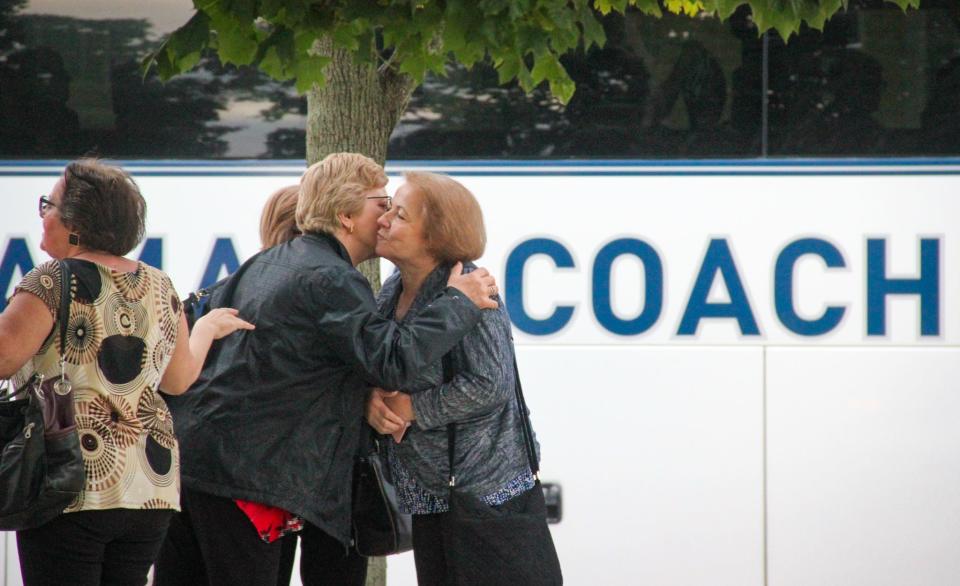 A bus full of feast-goers drops off relatives at the east side of Kennedy Park, near the the Great Feast of the Holy Ghost of New England on Thursday, Aug. 24, in Fall River.