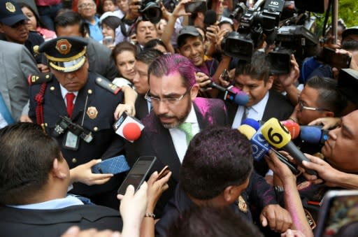 Mexico City's security minister, Jesus Orta, is covered with glitter as he appealed for calm on August 12