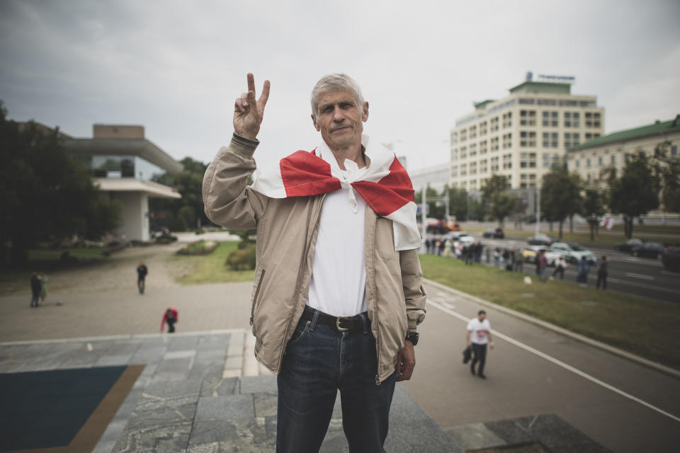 Alexander Yablonskiy, 67, a pensioner poses for a photo during an opposition rally in Minsk, Belarus, Thursday, Aug. 20, 2020. Behind each protester in Belarus is a surprising story of awakening. Holding signs or personal tokens of resistance, they described their fears and hopes to The Associated Press, after nearly two weeks of protests against President Alexander Lukashenko's 26-year rule. (AP Photo/Evgeniy Maloletka)