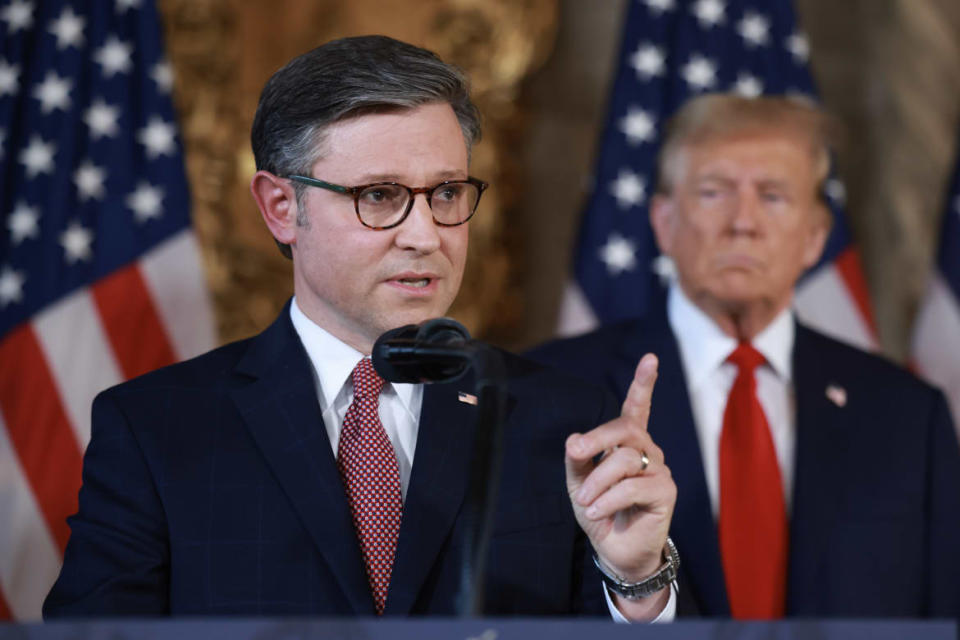 Former president Donald Trump listens as Speaker Mike Johnson (R-LA) speaks during a press conference at Mr. Trump's Mar-a-Lago estate.