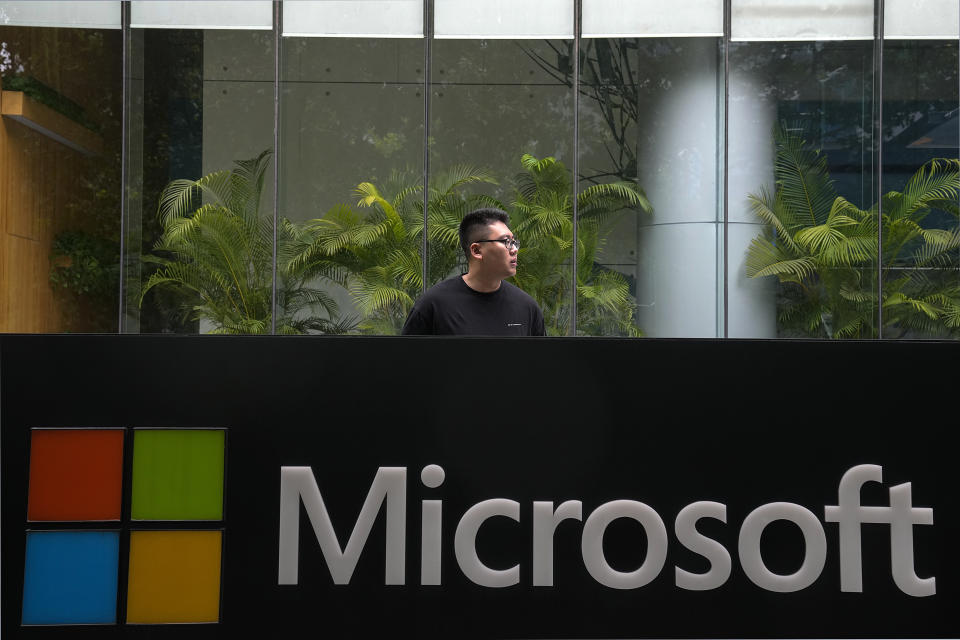 A man stands watch outside the Microsoft office building in Beijing, Tuesday, July 20, 2021. The Biden administration and Western allies formally blamed China on Monday for a massive hack of Microsoft Exchange email server software and asserted that criminal hackers associated with the Chinese government have carried out ransomware and other illicit cyber operations. (AP Photo/Andy Wong)