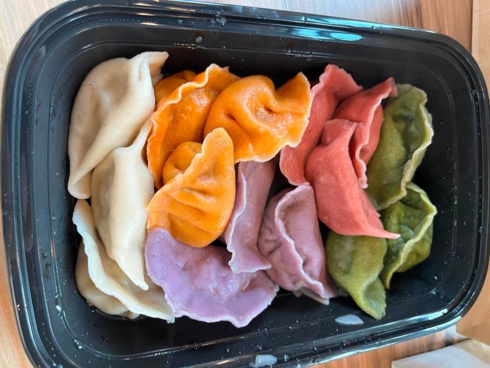 The colorful dumpling flight from Sun’s Kitchen comes with pork and Chive (white), beef and carrot (orange), chicken and mushroom (pink), veggie (green) and shrimp and chicken (violet). Heidi Finley/CharlotteFive