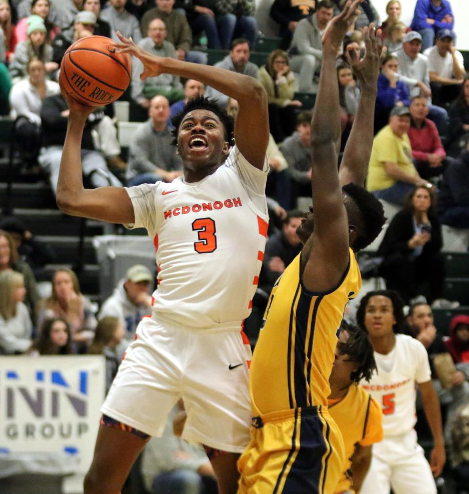 McDonogh's Robert Fields goes up for a shot as Caleb Andigue defends during a 50-44 win over Mount St. Michael Academy in the Boys National Division final at the Josh Palmer Fund Clarion Classic on Dec. 30, 2022 at Elmira High School.