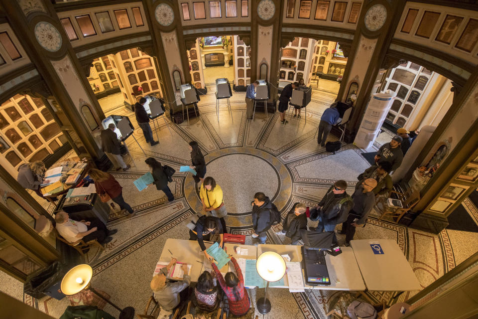 Voters stand in line to vote as others vote at the San Francisco Columbarium polling location in San Francisco, California, on Nov. 8.