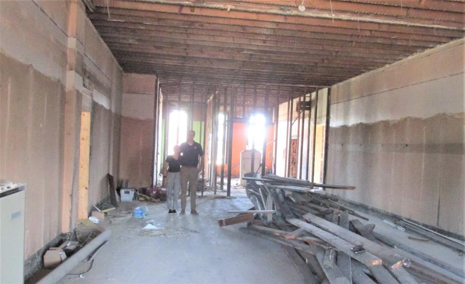 Dylan  and Jackie Kaufman look at one of the future apartments on the second floor of the American Hall building in downtown Millersburg.