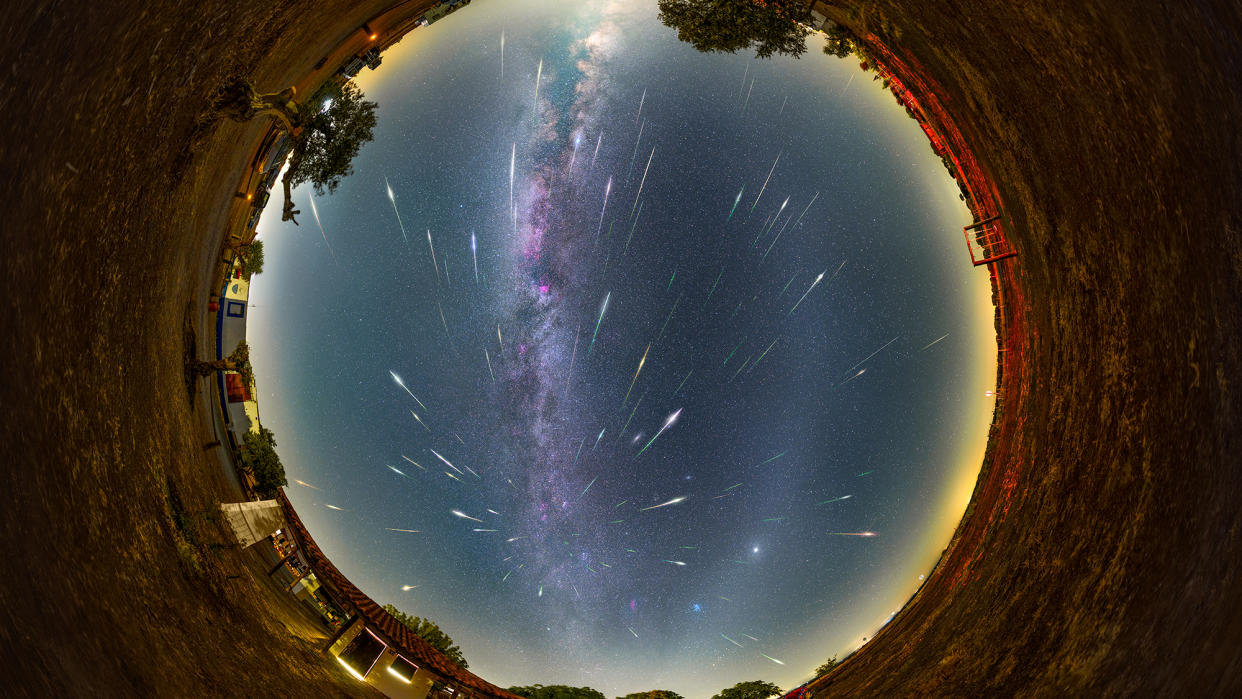  A circular overhead view of the sky and shooting stars and the milky way. 