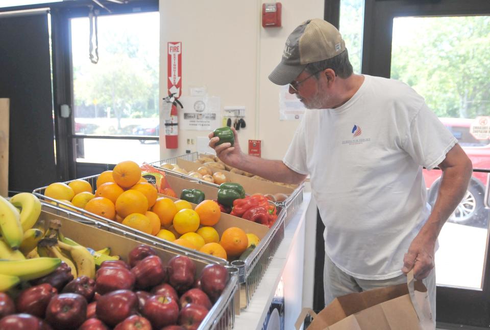 Jim Dunleavy, of Hyannis, looks through produce at the Cape and Islands Veterans Outreach Center food pantry in Hyannis. Dunleavy, a U.S. Marine Corps veteran, was one of several veterans picking up food on Sept. 7 at the distribution center. Volunteers and staff worked together to fulfill grocery lists for veterans. To see more photos, go to www.capecodtimes.com