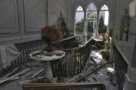 Broken glass and window frames lay on the floor of the 150-year-old Sursock Palace that was damaged by the Aug. 4 explosion that hit the seaport of Beirut, Lebanon, Monday, Sept. 14, 2020. Restoring Beirut's architectural heritage from the August blast will take hundreds of millions of dollars and costs will quickly rise if no action is taken ahead of the onset of the rainy season in less than two months time, international experts announced Tuesday. (AP Photo/Bilal Hussein)