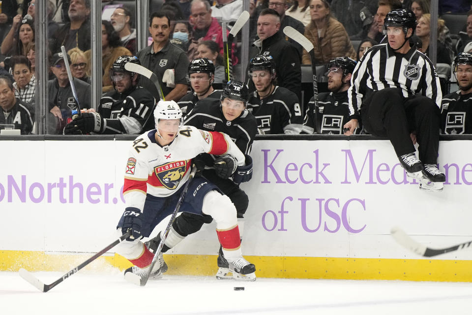 Florida Panthers defenseman Gustav Forsling, left, and Los Angeles Kings center Trevor Moore collide as they battle for the puck during the first period of an NHL hockey game Thursday, Nov. 16, 2023, in Los Angeles. (AP Photo/Mark J. Terrill)