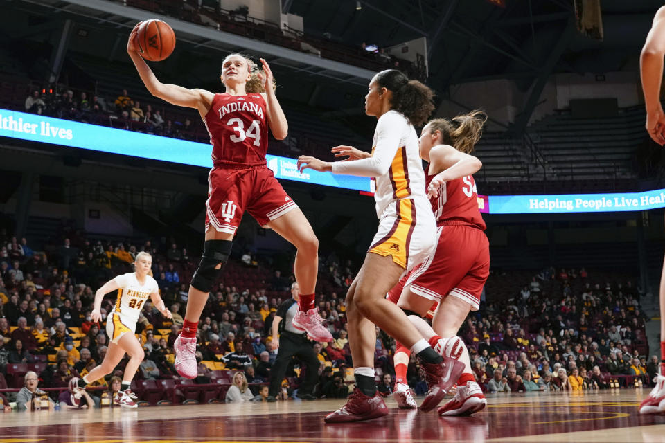 Indiana guard Grace Berger (34) grabs a rebound in front of Minnesota guard Angelina Hammond during the first half of an NCAA college basketball game on Wednesday, Feb 1, 2023, in Minneapolis. (AP Photo/Craig Lassig)