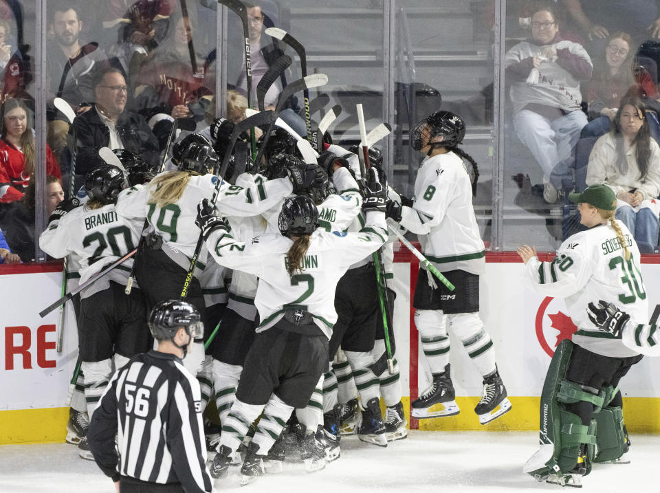 Boston celebrates a win over Montreal in overtime of Game 1 of a PWHL hockey playoff series Thursday, May 9, 2024, in Montreal. (Christinne Muschi/The Canadian Press via AP)