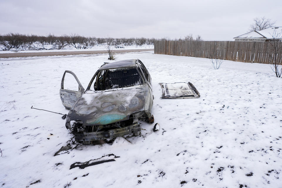 Snow covers a charred vehicle on a property destroyed by the Smokehouse Creek Fire, Thursday, Feb. 29, 2024, in Stinnett, Texas. (AP Photo/Julio Cortez)