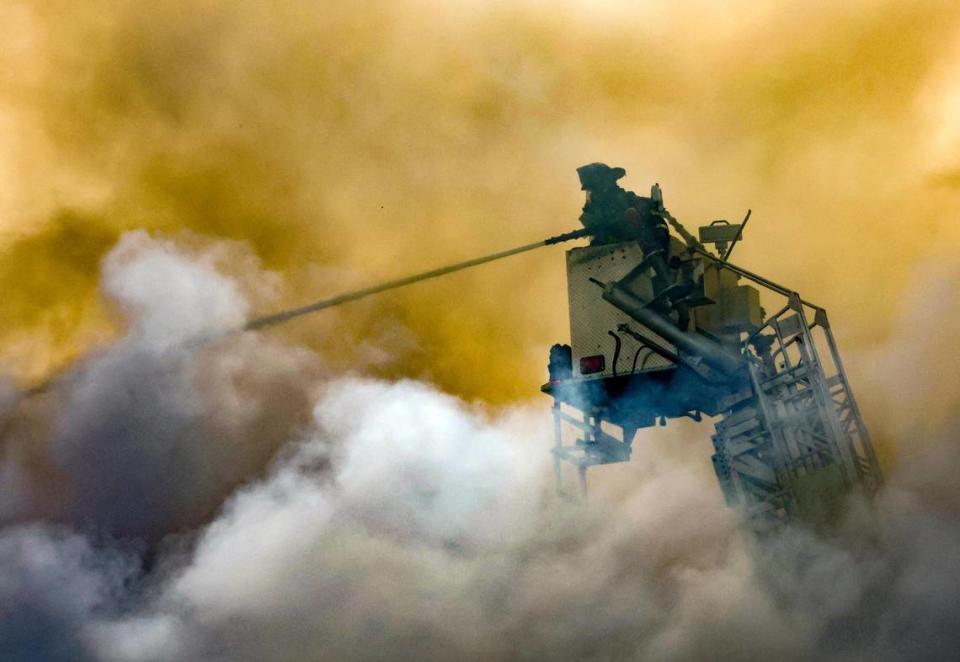 Miami-Dade firefighters battle a blaze at a two-story apartment building at 395 NW 177th St. on Saturday, Jan. 28, 2023.