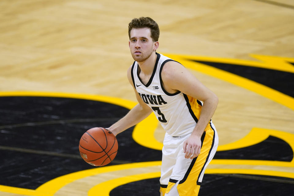 FILE - In this March 4, 2021, file photo, Iowa guard Jordan Bohannon brings the ball up during the team's NCAA college basketball game against Nebraska in Iowa City, Iowa. Former Iowa State football player Nicholas Kron was arrested in connection with an assault on Bohannaon in May. Kron, 29, of Nashville, Tenn., faces an assault causing bodily injury charge for allegedly attacking Bohannon outside a downtown Iowa City bar. (AP Photo/Charlie Neibergall, File)