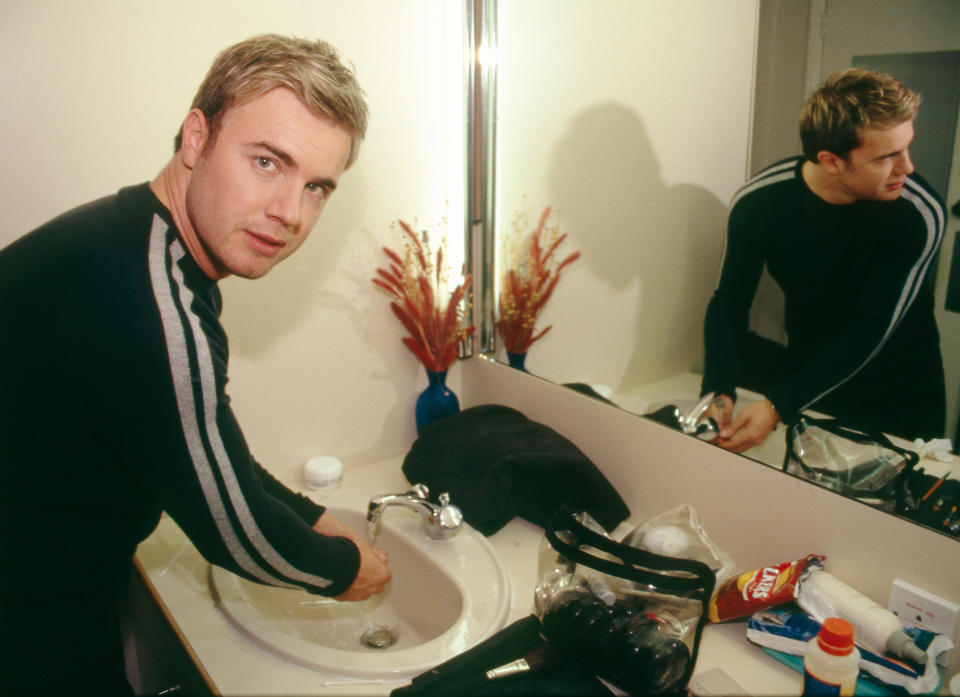Gary Barlow poses for a portrait in his dressing room, backstage at a TV show, London, 1999. (Photo by David Tonge/Getty Images)