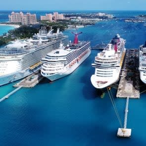 High Angle View Of Cruise Ships Moored In Sea Against Blue Sky