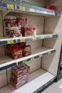 FILE - In this Feb. 21, 2020 file photo, Packages of instant noodles are displayed on almost empty shelves at a supermarket in Daegu, South Korea. As fears of a soaring viral outbreak grip the southeastern South Korean city of Daegu and nearby areas, many residents are struggling as they try to avoid the new virus. (AP Photo/Noh Yeo Jin, File)