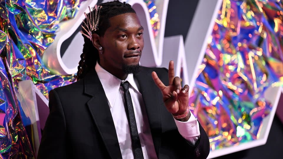 Offset adorned his hair with silver clips to match the dress worn by his wife Cardi B. The rapper also paired his dark suit with a black and silver buckled belt, sparkly skinny tie and silver jewelry. - Evan Agostini/Invision/AP