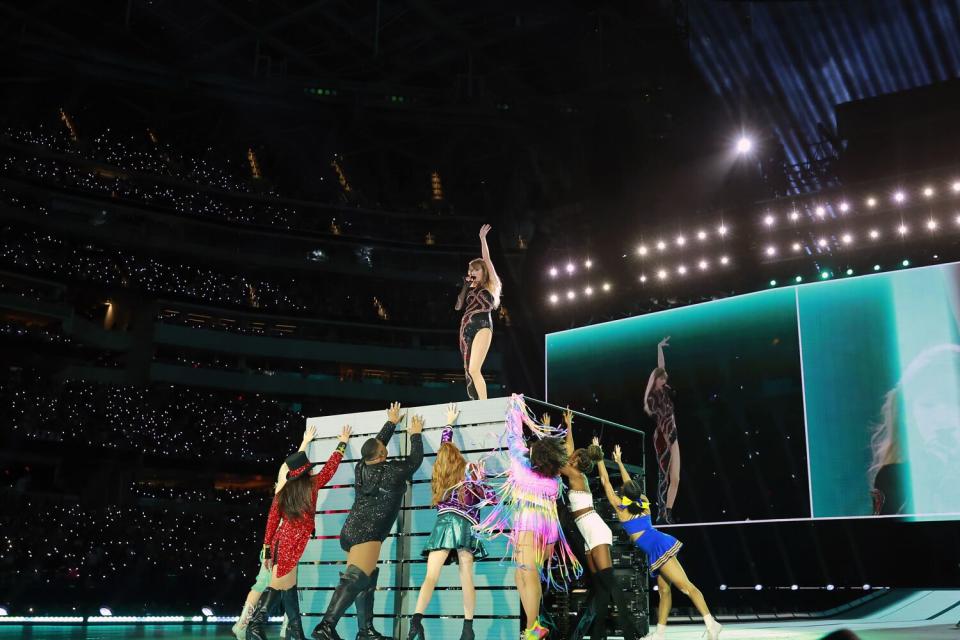 Taylor Swift and dancers perform onstage.