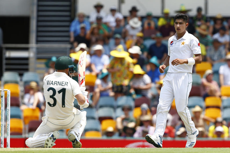 Pakistan's Naseem Shah, right, stares at Australia's David Warner, left, after he bowled a bouncer during their cricket test match against Australia in Brisbane, Australia, Friday, Nov. 22, 2019. (AP Photo/Tertius Pickard)