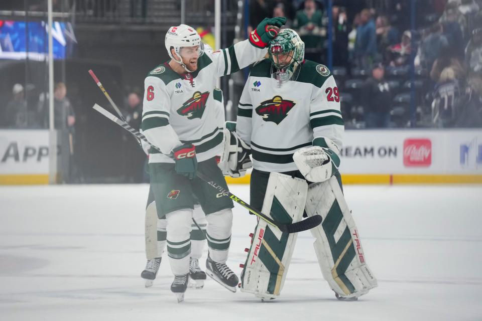 Defenseman Dakota Mermis (6) congratulates goaltender Marc-Andre Fleury (29) after the Minnesota Wild defeated the Columbus Blue Jackets in overtime.