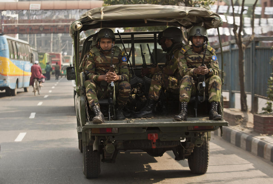 Bangladeshi army soldiers sit inside a vehicle as they patrol the streets on the eve of the general elections in Dhaka, Bangladesh, Saturday, Dec. 29, 2018. Bangladesh Prime Minister Sheikh Hasina is poised to win a record fourth term in Sunday's elections, drumming up support by promising a development bonanza as her critics question if the South Asian nation's tremendous economic success has come at the expense of its already fragile democracy. (AP Photo/Anupam Nath)