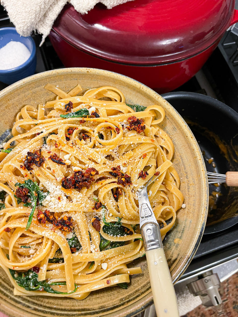 twirling pasta around fork in a plate