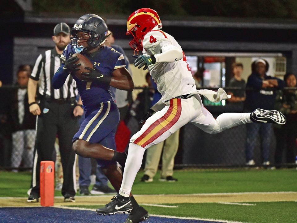 University Christian's Jenoa Alford (7) goes into the end zone for a touchdown while being defended by Clearwater Central Catholic's Julian Allen (4) during late first quarter action. The Clearwater Central Catholic Marauders traveled to Jacksonville, FL to take on the University Christian Christians in the Florida High School Athletic Association Class 1M starts football semifinal match Friday, December 2, 2022. The Marauders came away with a 29 to 34 win over the Christians.