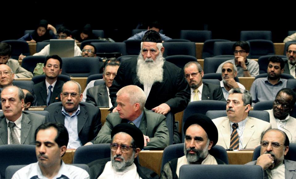 FILE - In this Tuesday, Aug. 1, 2006 file photo, Iran's Jewish community chief rabbi, Yousef Hamedani Cohen, center, arrives at a conference of Iranian parties to show support for Palestinians and Lebanon, in Tehran, Iran. Cohen, Iran's former chief rabbi and one of the cornerstones of its tiny Jewish community, has died. He was 98. (AP Photo/Vahid Salemi, File)