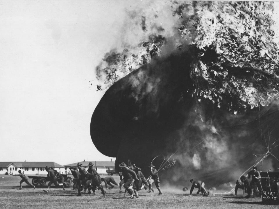 Soldiers run away from a burning observation balloon that crashed at Fort Sill in Lawton, Oklahoma, in 1918.