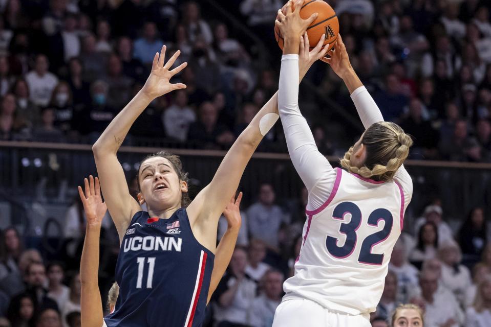 Villanova guard Bella Runyan (32) grabs a pass intended for UConn forward Lou Lopez Senechal (11) during the first half of an NCAA college basketball game, Saturday, Feb. 18, 2023, in Villanova, Pa. (AP Photo/Laurence Kesterson)