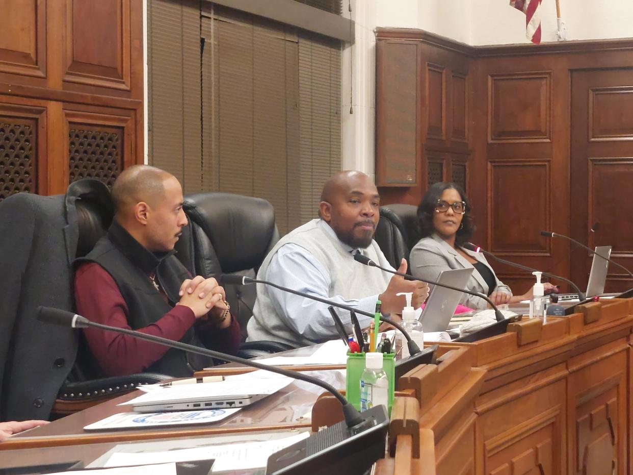 Akron's Citizens' Police Oversight Board Chair Kemp Boyd in November discusses moving the board's rules package to Akron City Council for approval as board member Brandyn Costa and administrative assistant Shannon Thompson look on.