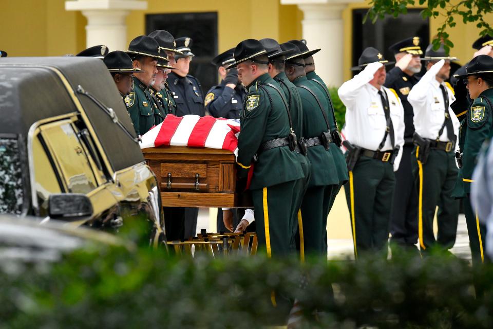 St. Johns County sheriff's deputies remove the coffin of Sgt. Michael Kunovich from the hearse for his funeral service on May 26. The 52-year-old experienced medical distress and died after detaining a young man for questioning.