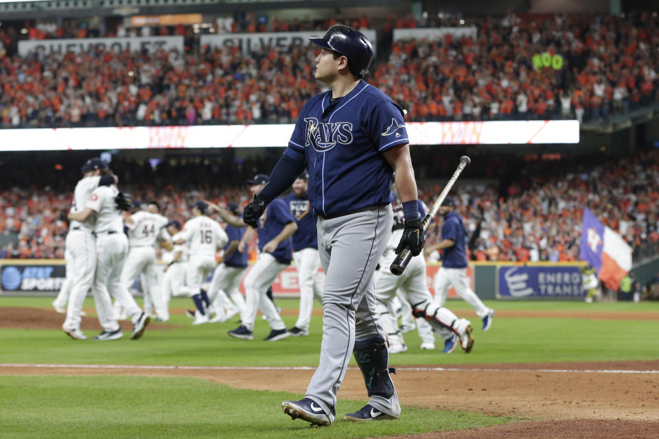 Tampa Bay Rays first baseman Ji-Man Choi walks off the field as the Houston Astros celebrate their win in Game 5 of a baseball American League Division Series in Houston, Thursday, Oct. 10, 2019. (AP Photo/Michael Wyke)