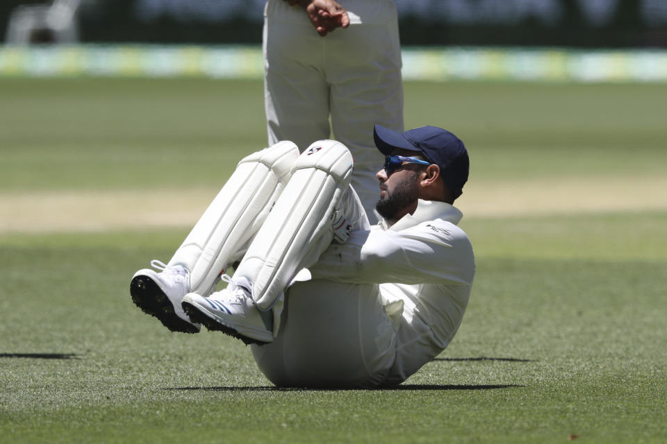 India's wicketkeeper Rishabh Pant lies on the ground to stretch during play in the second cricket test between Australia and India in Perth, Australia, Monday, Dec. 17, 2018. (AP Photo/Trevor Collens)