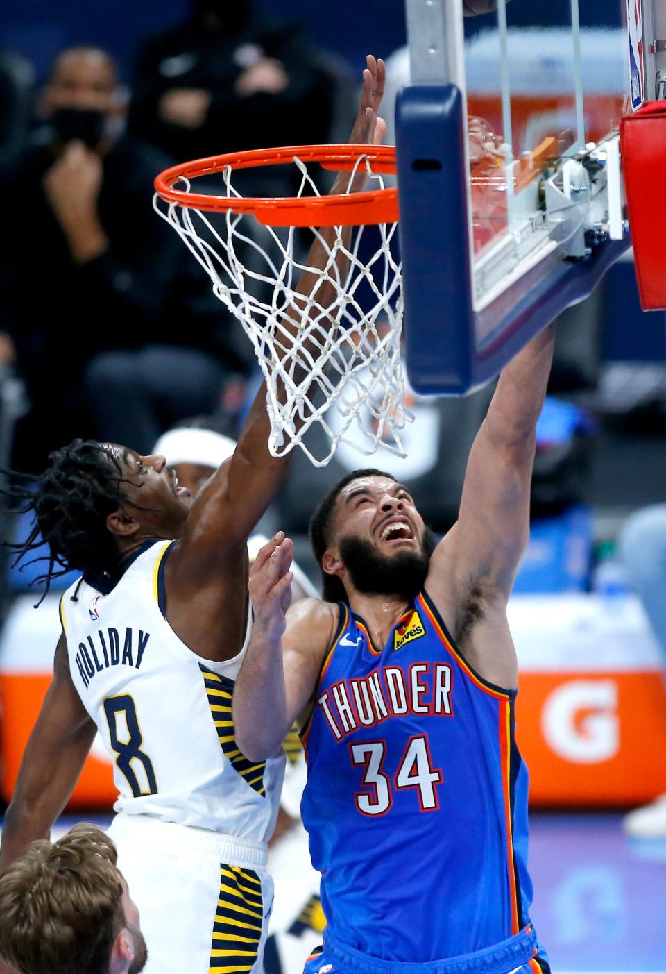 Oklahoma City's Kenrich Williams (34) goes up for a basket as Indiana's Justin Holiday (8) defends in the second quarter of the NBA basketball game between the Oklahoma City Thunder and the Indiana Pacers at the Chesapeake Energy Arena, Saturday, May 1, 2021, in Oklahoma City. 