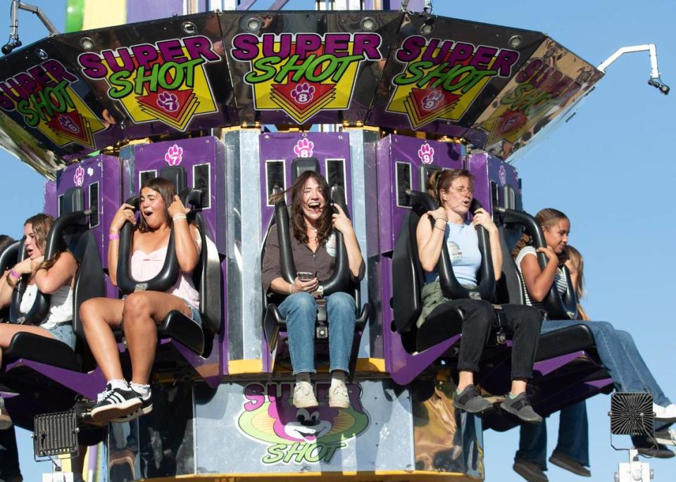 Tribune reporters Chloe Shrager, left, and Kelsey Oliver take on this year’s rides, games and food at the 2024 Mid-State Fair. The Paso Robles fair opened Wednesday, July 17, 2024. Shrager and Oliver scream on the Super Shot ride.