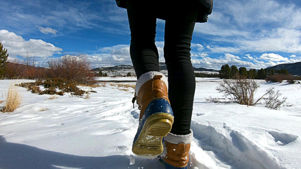 woman is walking along a footpath close to the lake