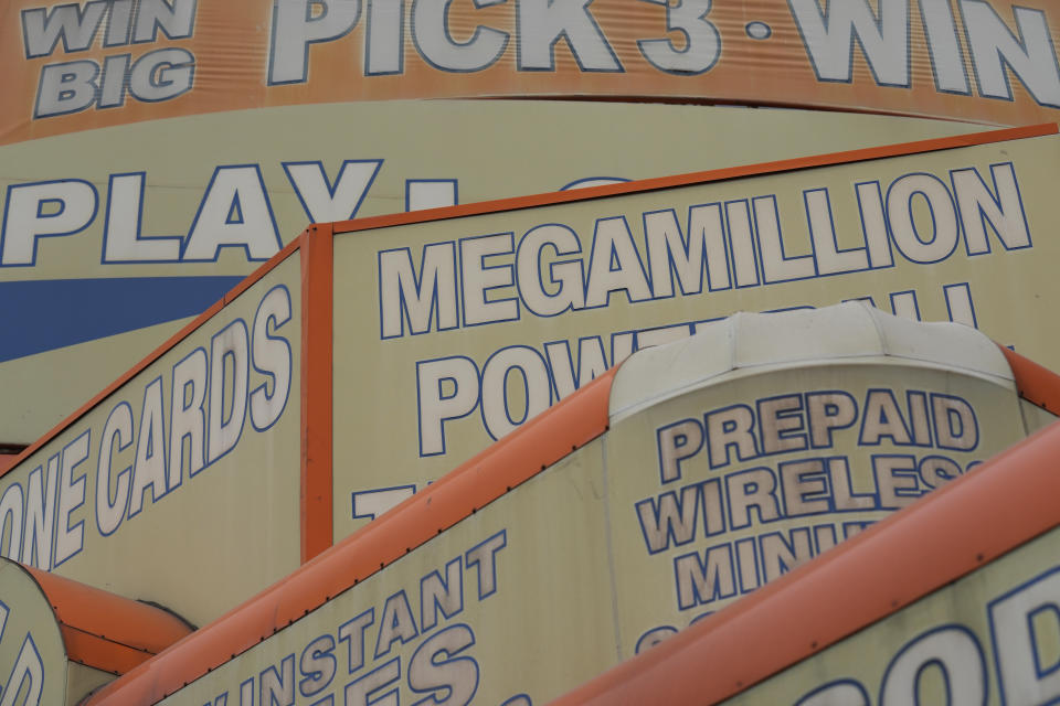 The awnings of a store advertise the sale of lottery tickets, including Mega Millions, Wednesday, Jan. 11, 2023, in New York. The Mega Millions prize has grown again to an estimated $1.35 billion after there was no winner of the lottery's latest giant jackpot. (AP Photo/Seth Wenig)