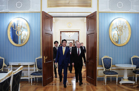 Russian President Vladimir Putin (R) and Japanese Prime Minister Shinzo Abe enter a hall during a meeting in Moscow, Russia January 22, 2019. Sputnik/Alexei Druzhinin/Kremlin via REUTERS