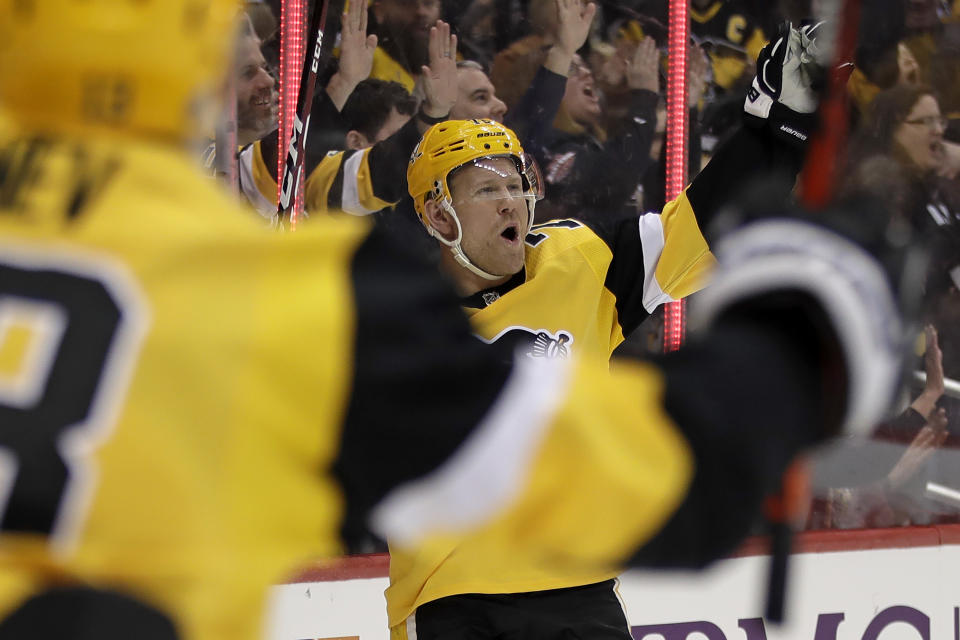 CORRECTS TO SECOND GOAL NOT THIRD GOAL AS A SCORING CHANGE TOOK AWAY HORNQVIST’S FIRST-PERIOD GOAL AND THAT SCORE WAS LATER CREDITED TO SAM LAFFERTY - Pittsburgh Penguins' Patric Hornqvist, center, celebrates his second goal of the team's NHL hockey game against the Detroit Red Wings during the second period in Pittsburgh, Sunday, Feb. 16, 2020. (AP Photo/Gene J. Puskar)