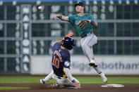 Seattle Mariners shortstop Dylan Moore, right, turns a double play on Houston Astros' Victor Caratini after forcing out Joey Loperfido (10) at second base during the eighth inning of a baseball game Saturday, May 4, 2024, in Houston. (AP Photo/Kevin M. Cox)